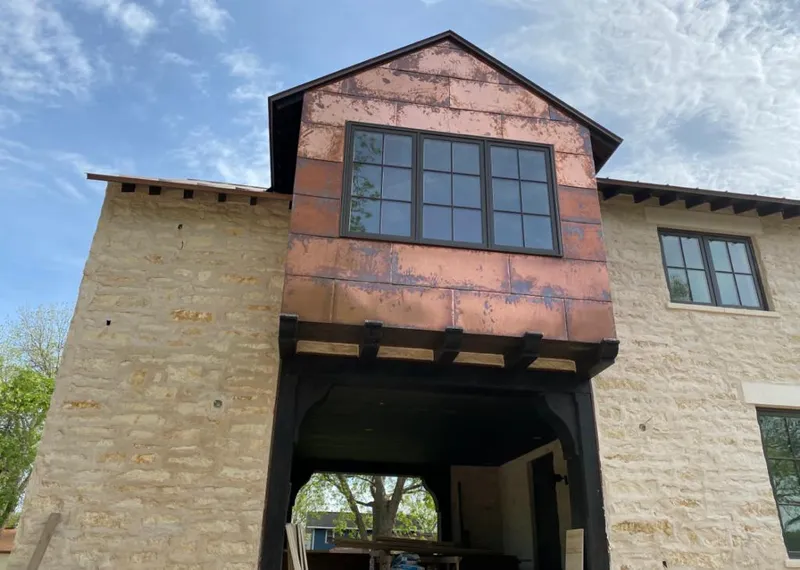 Copper metal panel facade on a stone building for Roof Repair in University of California-Santa Barbara